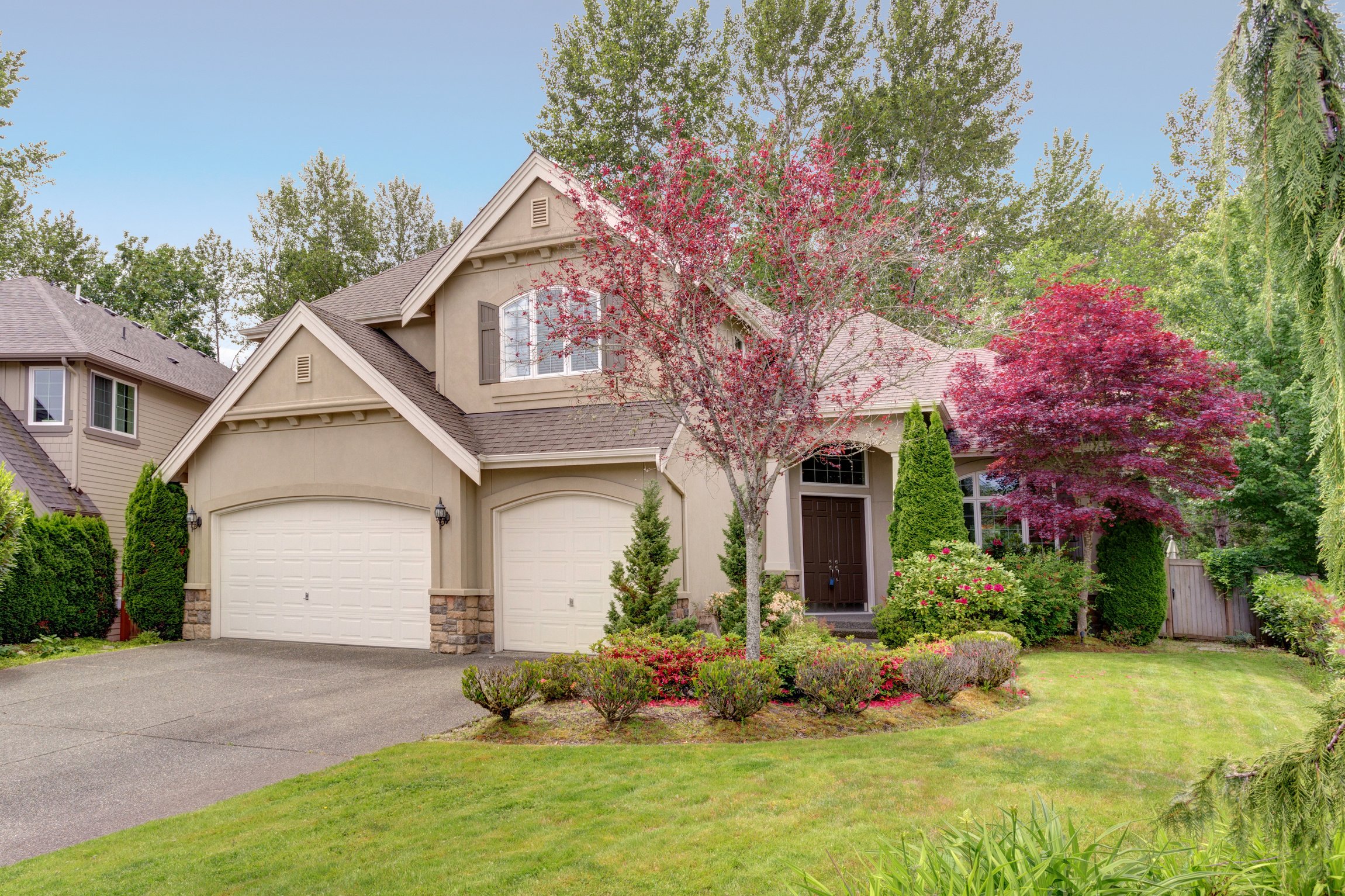 Exterior of a lovely house with well kept front yard.